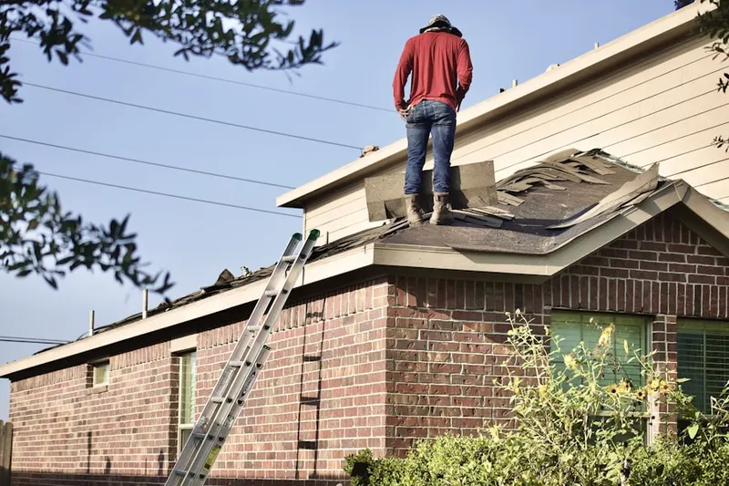 Professional roofer working on a residential roof in Little Washington
